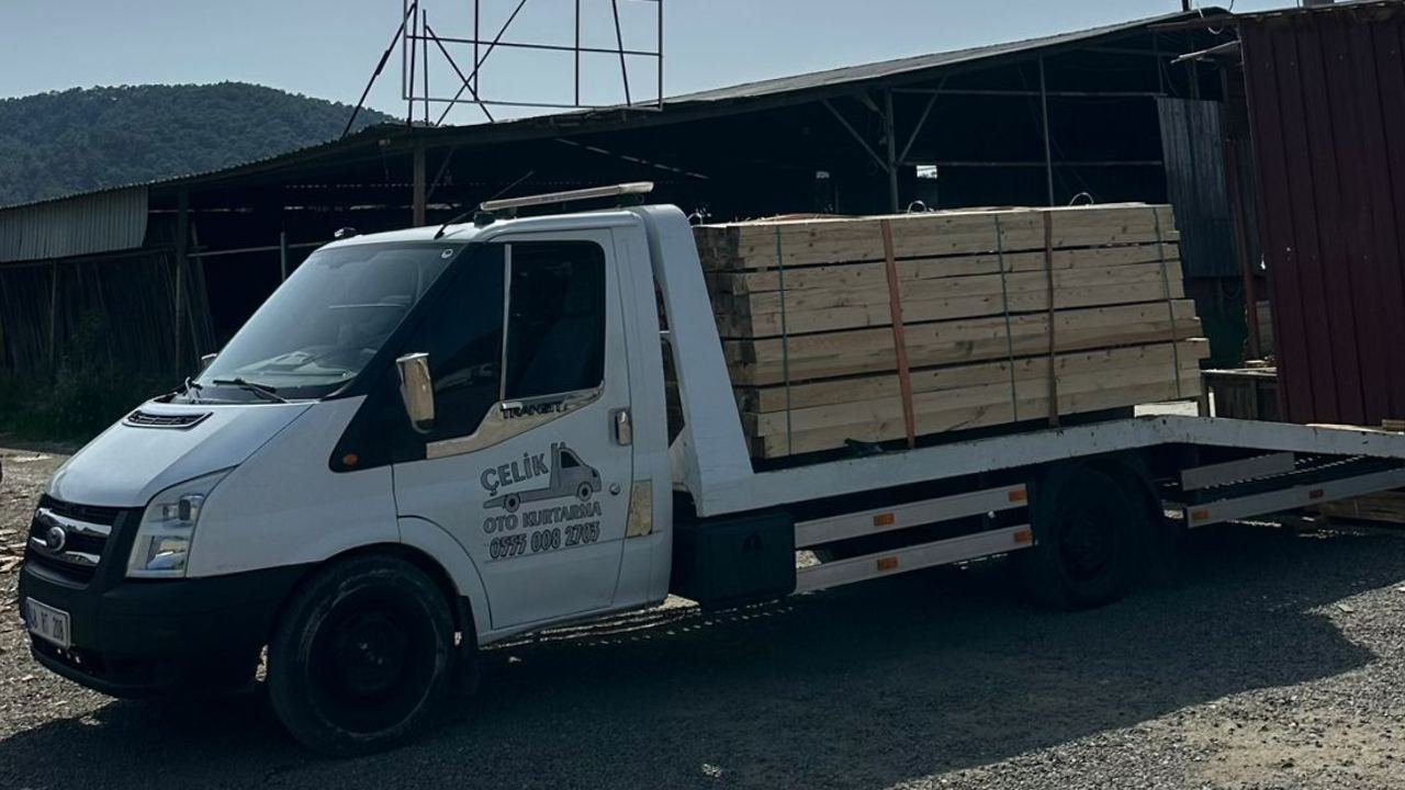 Çelik Oto Kurtarma çekicisi yük taşırken, akşam ışığında